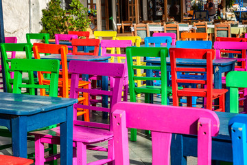 Bright colored wooden chairs in an outdoor cafe