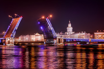The illuminated opened-up Dvorcoviy Bridge at night in Saint Petersburg, Russia