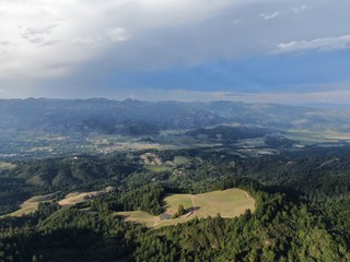 Aerial view of the verdant hills with trees in Napa Valley during summer season. Napa County, in California&rsquo;s Wine Country, Part of the North Bay region of the San Francisco Bay Area. Vineyard area.