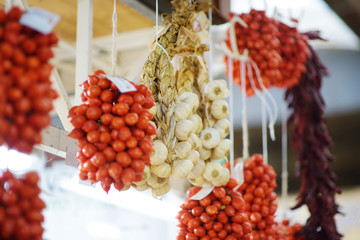 Bunches of organic garlic and cherry tomatoes sold on a marketplace in Genoa, Italy
