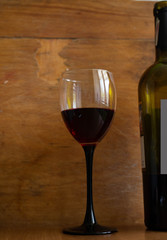 A glass of red wine on a wooden background