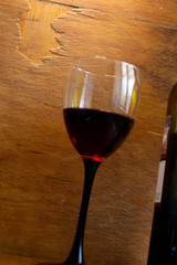 A glass of red wine on a wooden background