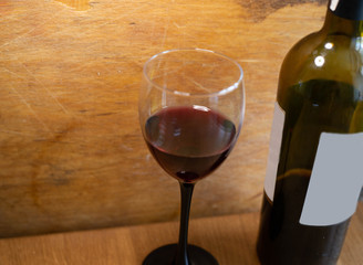 A glass of red wine on a wooden background