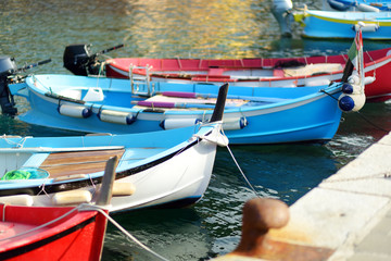 Colourful fishing boats in small marina of Vernazza, one of the five centuries-old villages of Cinque Terre, located on rugged northwest coast of Italian Riviera.