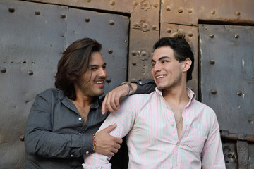 Happy gay couple visiting a medieval place in Catalonia