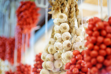 Bunches of organic garlic and cherry tomatoes sold on a marketplace in Genoa, Italy