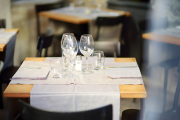 Beautifully decorated small outdoor restaurant tables in the city of Lucca, Tuscany, Italy