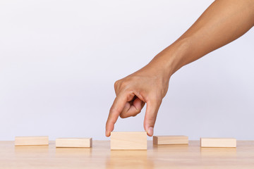 Hand choose empty wooden blocks on white background. Concept of decision making and choices success in the future goal
