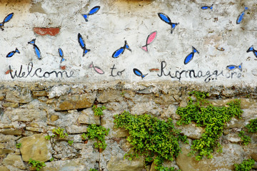 'Welcome to Riomaggiore' sign in Riomaggiore, the largest of the five centuries-old villages of Cinque Terre, Italian Riviera, Liguria, Italy.