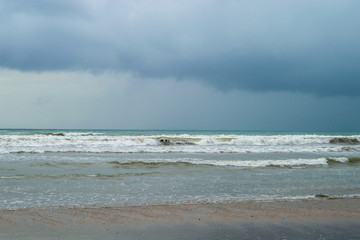 Beautiful stormy sea landscape on the beach summer photo on the sea coast. Dramatic cloudy sky, stormy weather. Summer holiday and vacation concept for tourism.  Free space for your text.