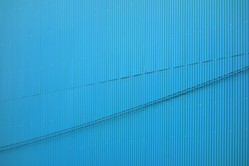 Blue tin wall and electric wire    