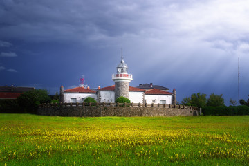 Fototapeta na wymiar Getxo lighthouse in La Galea with beautiful stormy light