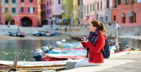 Young female tourist enjoying the view of Vernazza, one of the five centuries-old villages of...