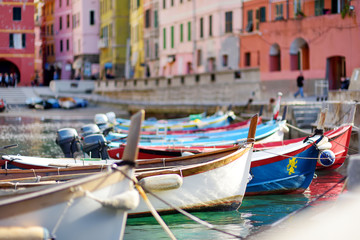 Fototapeta na wymiar Colourful fishing boats in small marina of Vernazza, one of the five centuries-old villages of Cinque Terre, located on rugged northwest coast of Italian Riviera.