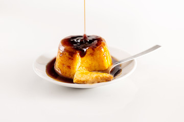 Creme caramel dessert or flan on white table. Delicious pudding served with liquid caramel