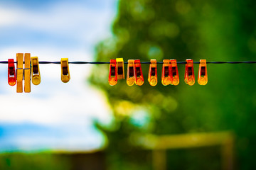 many clothespins hanging on a wire