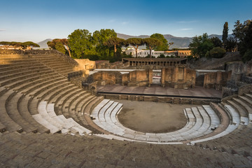 Ruins of amphitheatre at sunset, Pompeii, ancient roman city near Vesuvius volcano, Italy