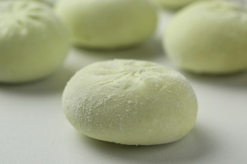 Frozen raw dumpling on white background, closeup