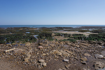 View out to sea across the beach and rock pools at Scarborough, Yorkshire, UK