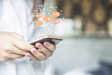 woman hand using smart phone with technology social media and network icon background 