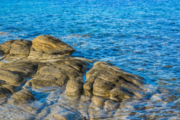 Mediterranean sea simple background scenic landscape clean nature concept photography of waterfront with picturesque stones and vivid bright blue water ripple surface, copy space for text