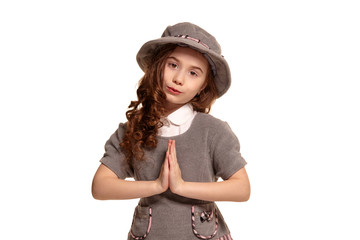 Studio shot of a lovely little kid with a long, curly hair posing isolated on white background.