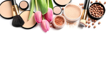 Naklejka na ściany i meble Many different makeup products and spring flowers on white background, top view