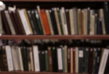 Blurred view of shelves with books in library