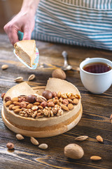 Piece of raw nutty cake on a blue wooden background. Healthy fresh summer vegan dessert. Gluten free and sugar free food