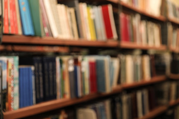 Blurred view of shelves with books in library