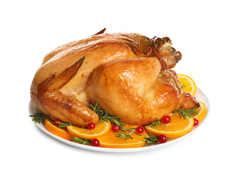 Platter of cooked turkey with garnish on white background