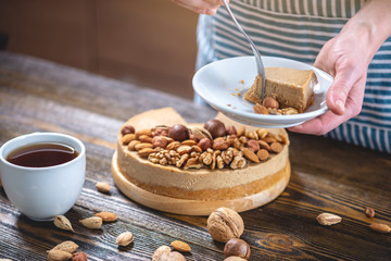 Piece of raw nutty cake on a blue wooden background. Healthy fresh summer vegan dessert. Gluten free and sugar free food