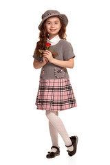 Full length shot of a lovely little kid with a long, curly hair posing isolated on white background.
