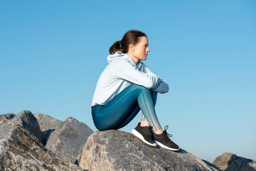 Woman sitting alone outdoors