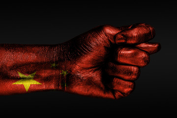 A hand with a painted China flag shows a fig, a sign of aggression, disagreement, a dispute on a...