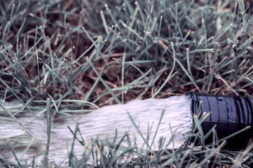 residential sump pump discharging water from the end of a flexible black hose