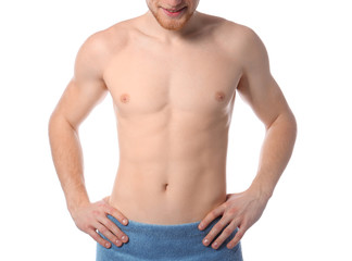Fototapeta premium Young man with slim body in towel on white background, closeup