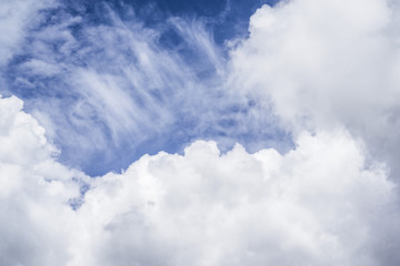 Fluffy white clouds on a blue sky background