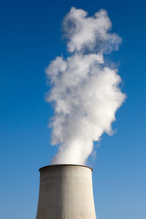 Smoking chimney against the blue sky, environmental pollution concept.