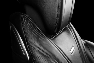 Black leather interior of the luxury modern car. Perforated leather comfortable seats with...