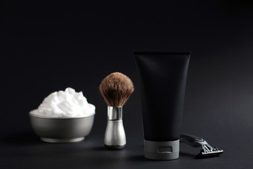 Set of shaving equipment and men's cosmetic products on black background