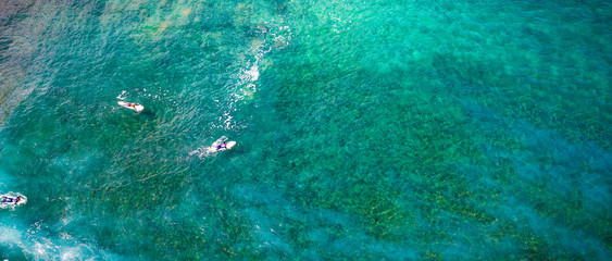 Aerial view of surfers on ocean and summer time 