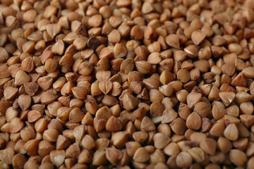 Uncooked buckwheat as background, closeup. Organic wholesome product
