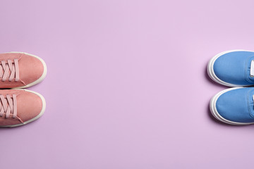 Different bright stylish shoes on color background, flat lay. Space for text