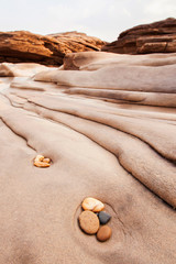 Harmony pebbles and layers of steep sandstone.