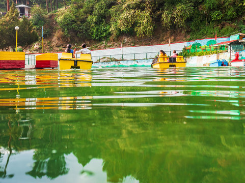 people enjoying pedaled boat ride surrounded by scenic beauty in the man-made lake  on way to the hill station Mussoorie- image 