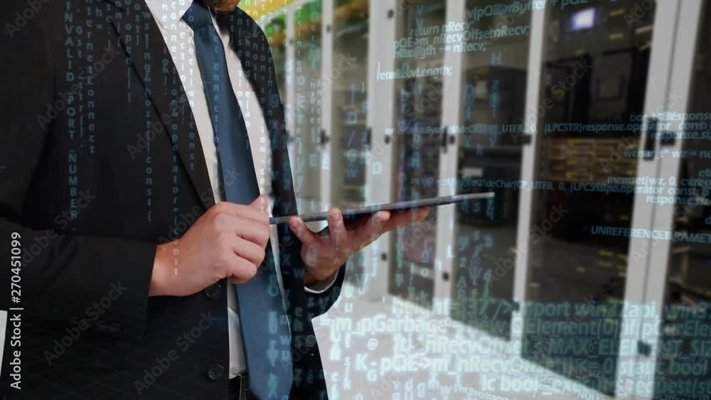 Poster man using digital tablet in front of server towers.
