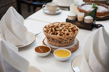 Traditional russian baked goods: pies and pretzels, samovar, honey, jam on the served table