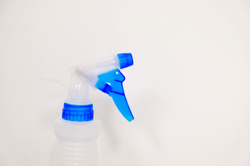 Plastic spray bottle in clean environment, cleaning concept with room for text.