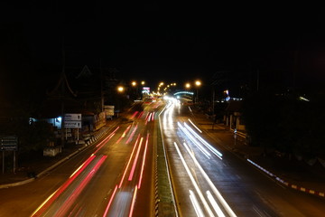 Fototapeta na wymiar Lightning behind at the traffic in the city at night